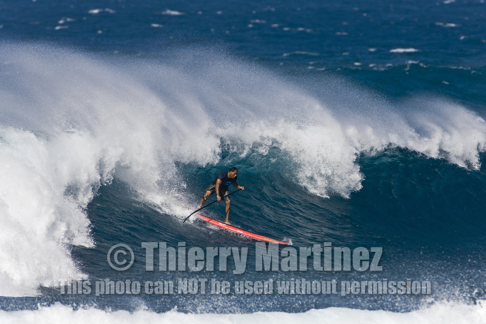 Stand Up Paddle  in waves at Hookip'a Beach - North Shore Maui - Hawaii.