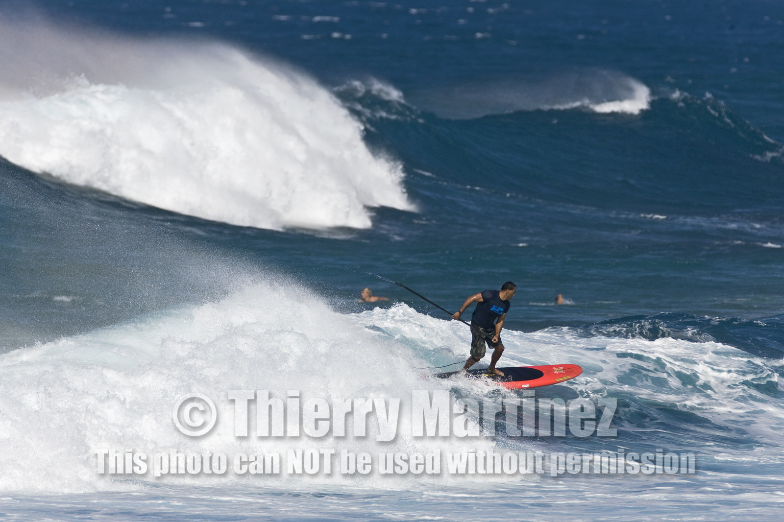 Stand Up Paddle  in waves at Hookip'a Beach - North Shore Maui - Hawaii.