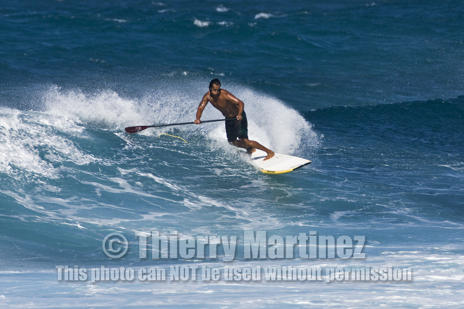 Stand Up Paddle  in waves at Hookip'a Beach - North Shore Maui - Hawaii.