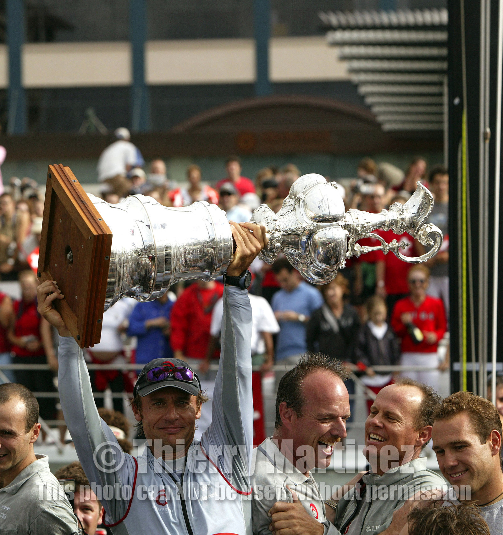 03_1448D © Th.Martinez . Auckland   New Zealand. 2nd March 2003 America's Cup 2003. Day 5, Alinghi (SUI64) vs Team New Zealand (NZL82). Alinghi winner of the 31st America's Cup. Docking ceremony, presentation of the America's Cup in the Viaduct Bassin.Ernesto Bertarelli (President and navigator) Holding The CUP