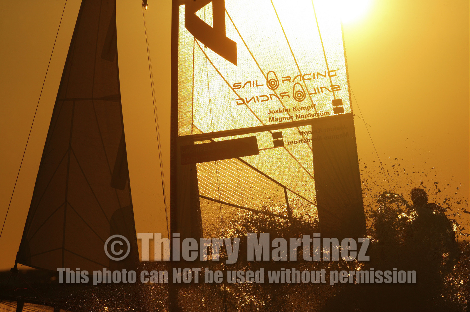 03_3243D  © Th.Martinez,STOCKHOLM ARCHIPELAGO SWEDEN, 10 07 03-Archipelago Raid (2003)  Day 3..Team NOKIA-Kempff  Magnus Nordstrom (SWE)& Joakim Kempff (SWE) sailing in sunset light on the way back from Finland to Sweden.