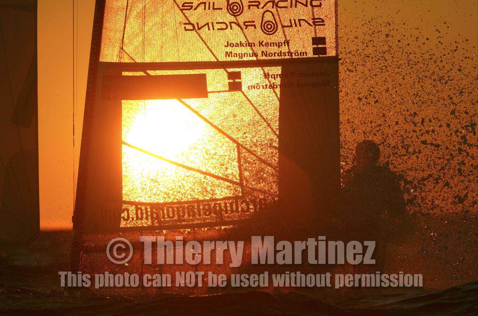 03_3252D © Th.Martinez,STOCKHOLM ARCHIPELAGO SWEDEN, 10 07 03-Archipelago Raid (2003)  Day 3..Team NOKIA-Kempff  Magnus Nordstrom (SWE)& Joakim Kempff (SWE) sailing in sunset light on the way back from Finland to Sweden.