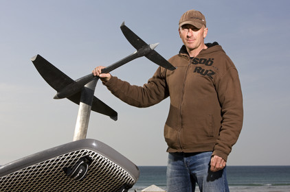 Bruno Andre (FRA) foiling with a windsurf.