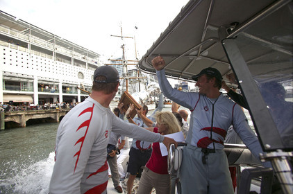 03_1502D ©Th.Martinez - Auckland (NZ) . America's Cup 2003. 2nd March 2003.Alinghi Team winner of America's Cup 2003..Ernesto Bertarelli driving the boat , on the way back from the Post America's Cup press conference to the Alinghi Base..Jochen Schuemann is showing The CUP to the public...