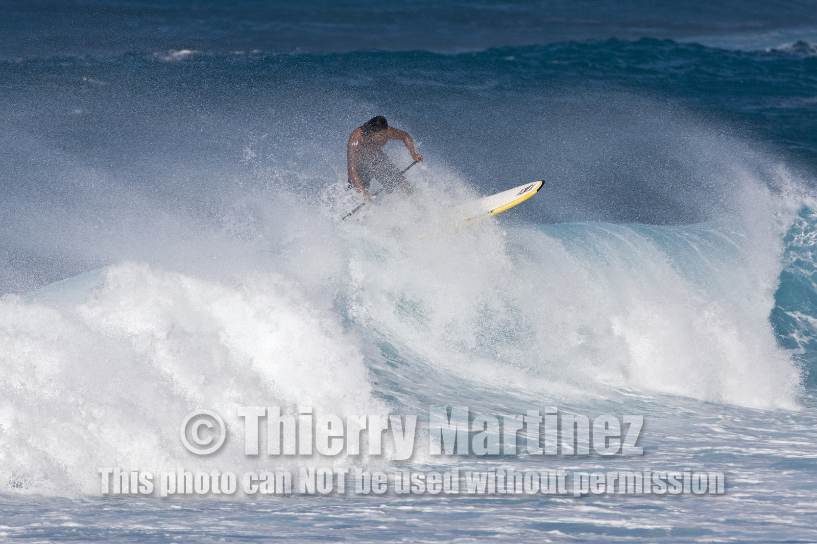 Stand Up Paddle  in waves at Hookip'a Beach - North Shore Maui - Hawaii.
