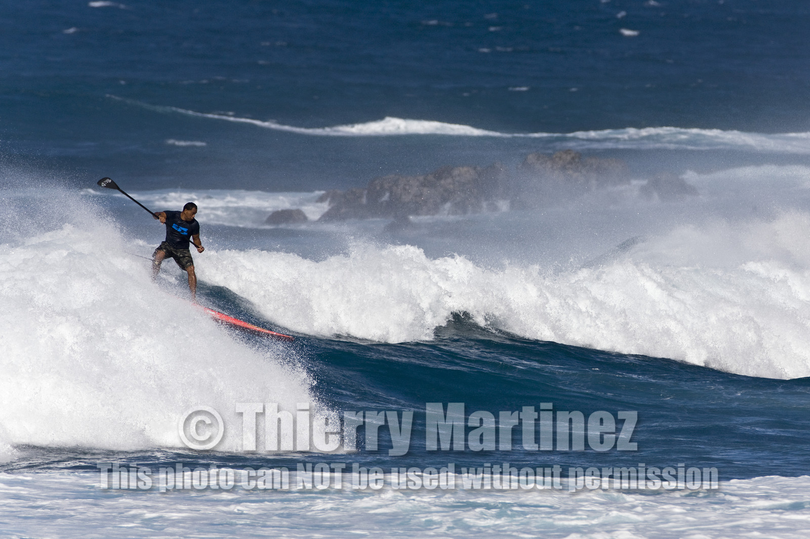Stand Up Paddle  in waves at Hookip'a Beach - North Shore Maui - Hawaii.